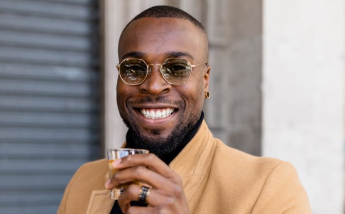  Man smiling while drinking espresso