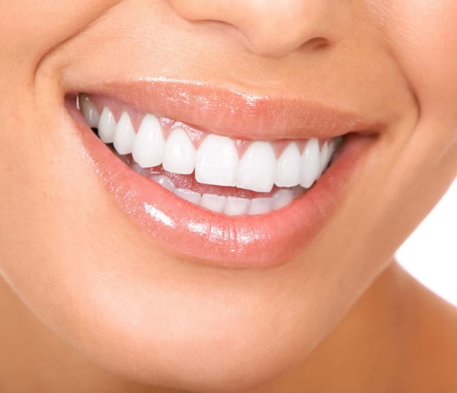close up of a womans face and her beautiful straight smile with white teeth.