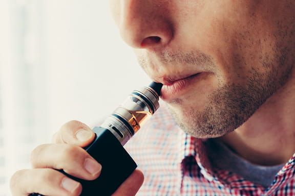 close-up shot of someone using a vape-pen